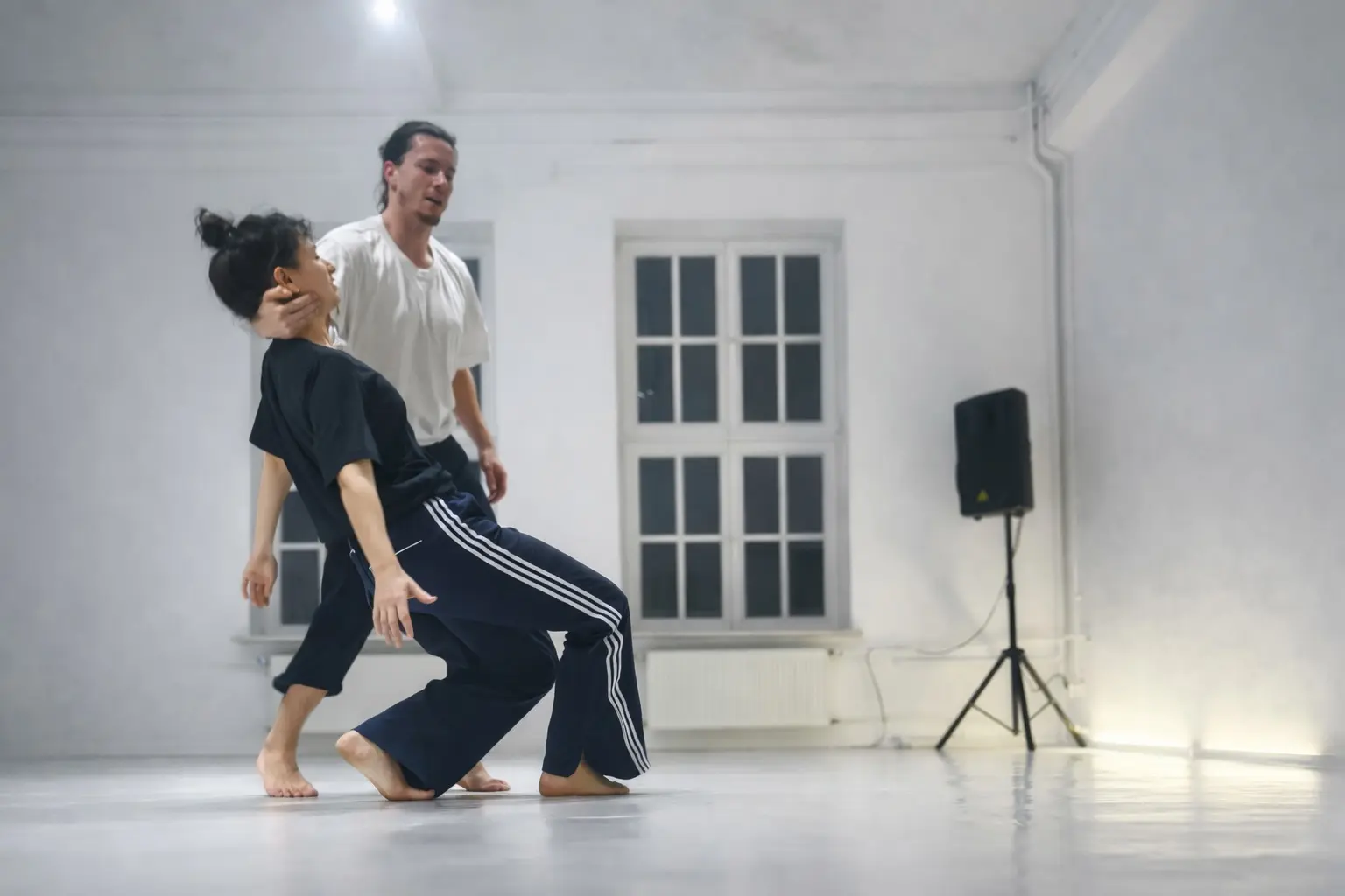 Contactish dancers sharing a grounded, playful moment